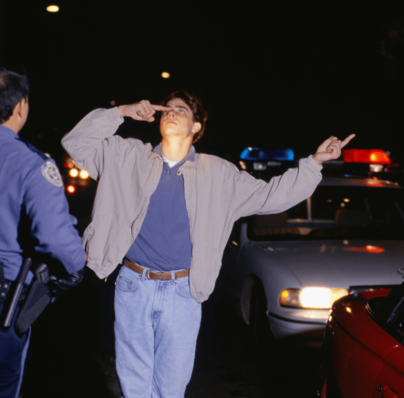 Man performing field sobriety test after being stopped by law enforcement